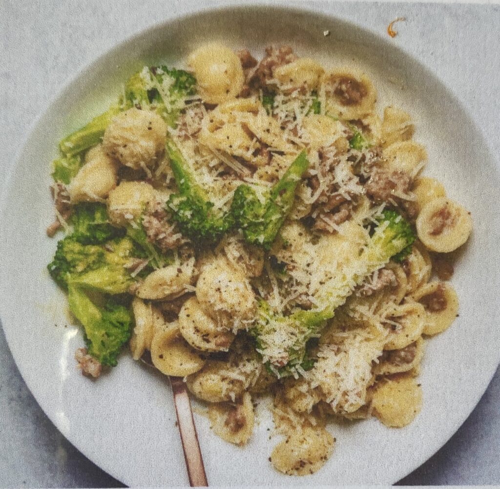 Orecchiette with spicy sausage and broccoli sauce with pecorino scattered over.