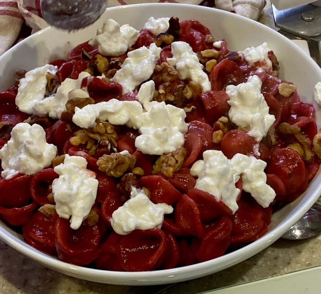 A dish of beetroot and ricotta pasta.